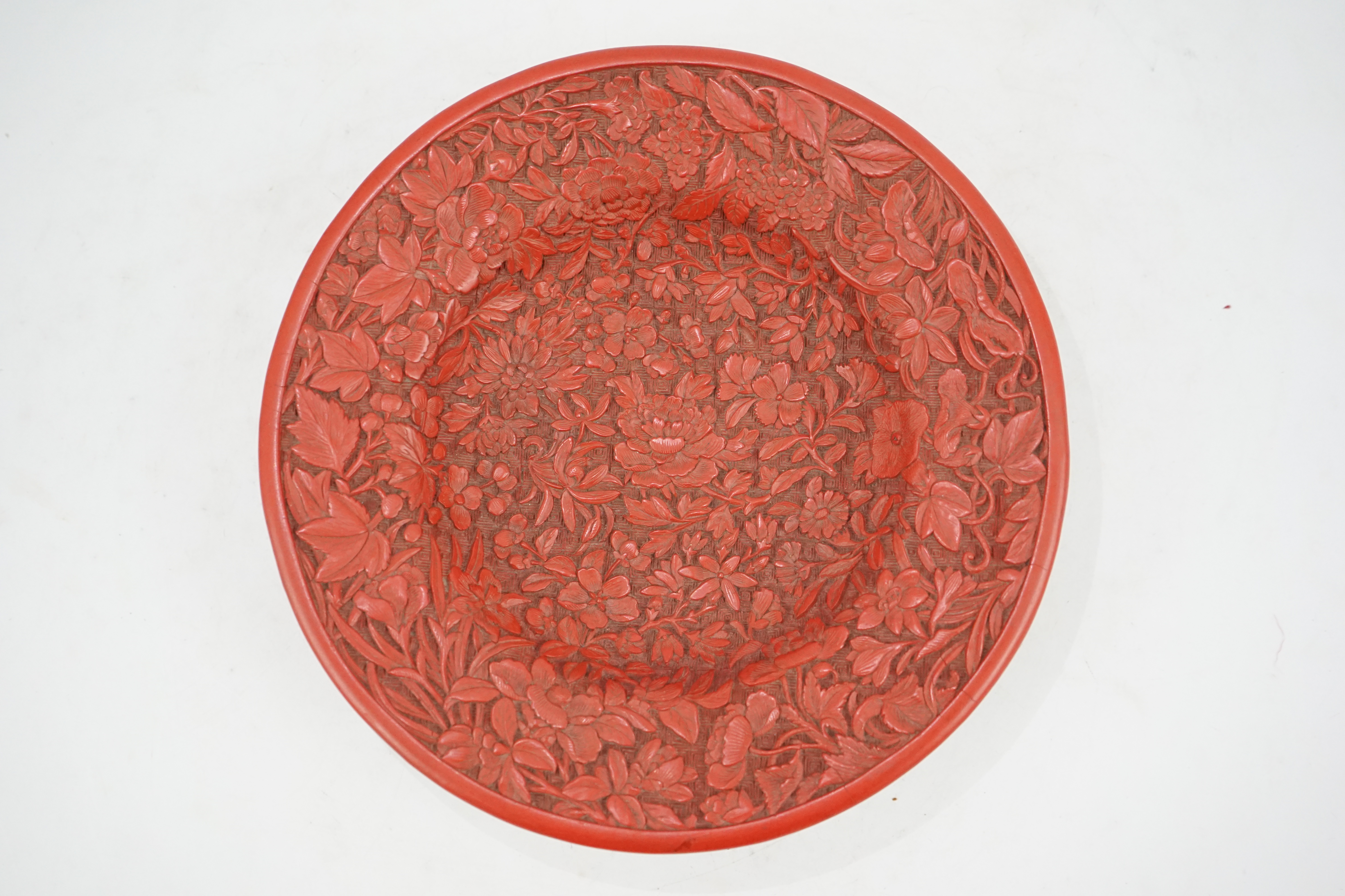 An unusual Chinese cinnabar lacquer ‘thousand flower’ footed dish, 18th/19th century